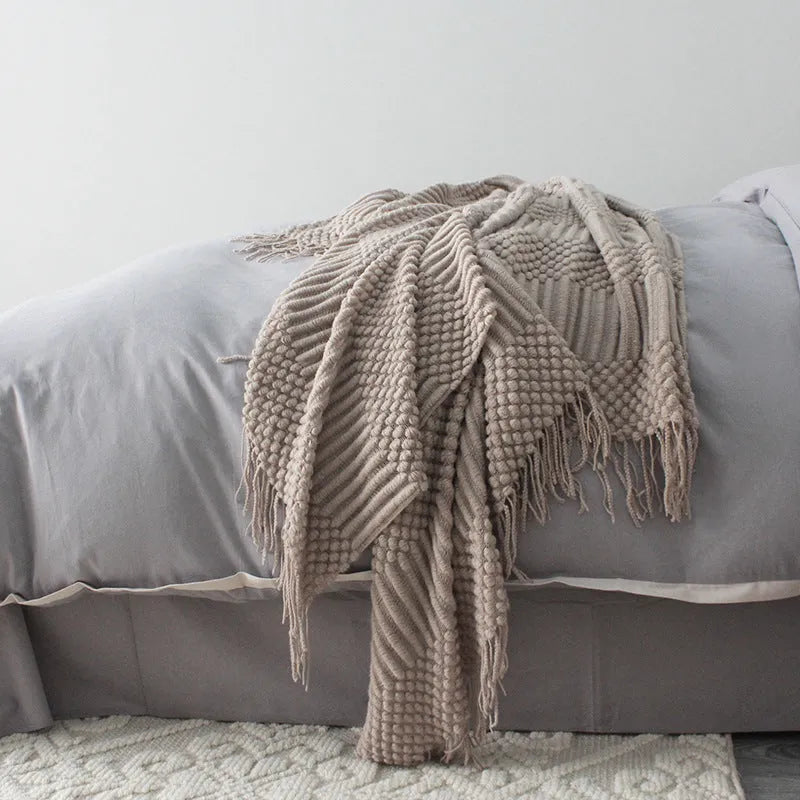 Small polyester blanket in dark grey, khaki or light grey colours measuring 127 by 170 centimetres