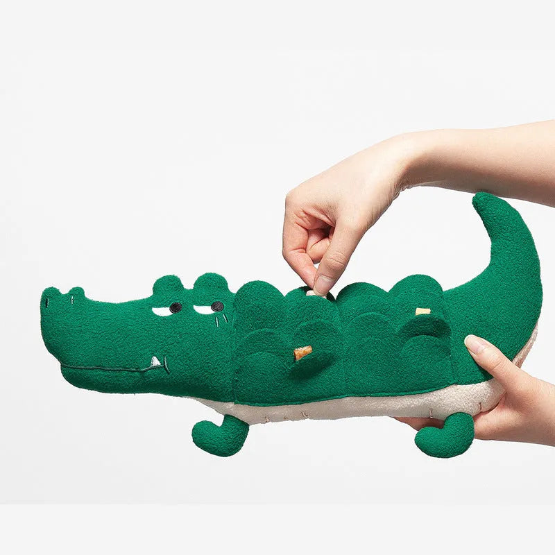 Green soft plush dog toy with embroidered face featuring squeaker and rattle for infant play