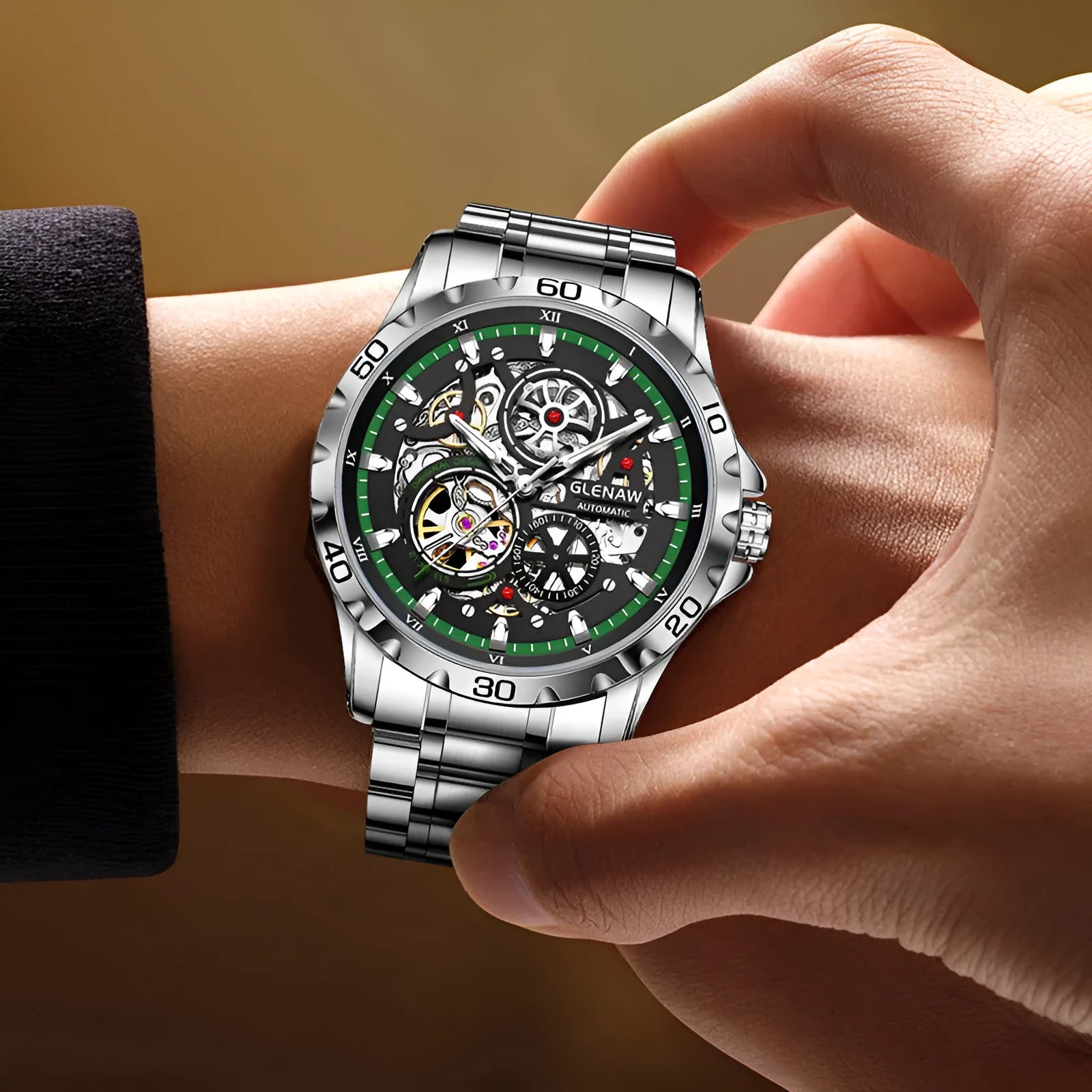 Silver automatic mechanical watch with hollow-out design showing luminous dial and stainless steel strap