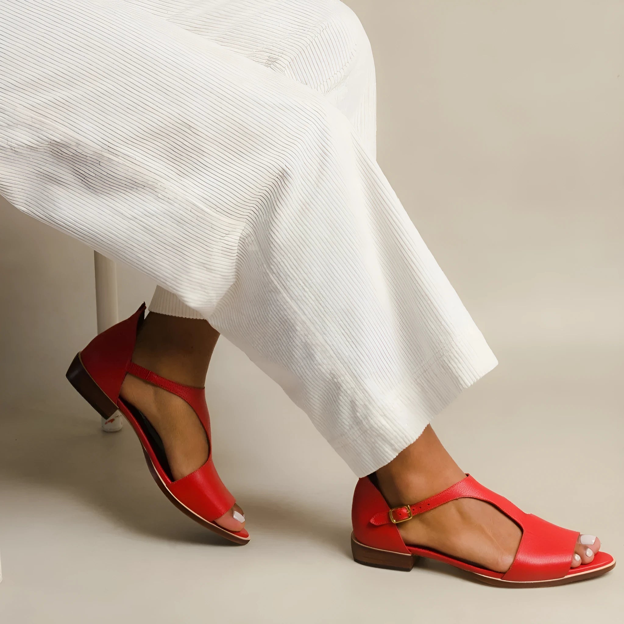 Red women's casual sandals with a square buckle and herringbone toe strap.