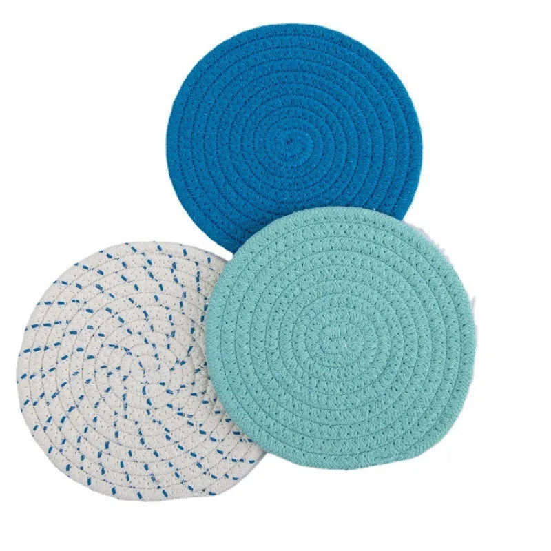 Set of three round grey cotton cord coasters, each 18 cm in diameter, on a wooden table.