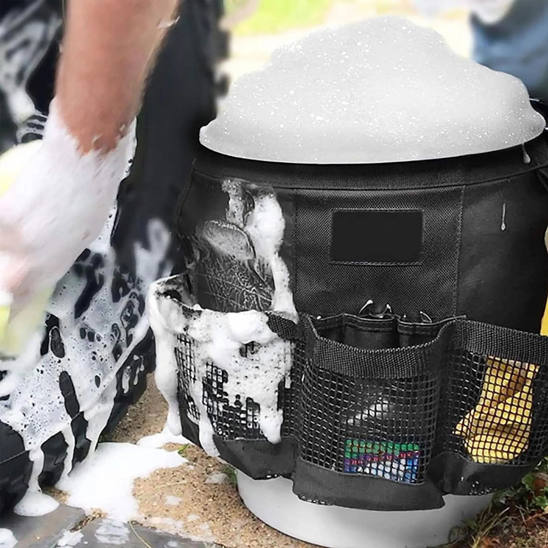 Black cylindrical polyester storage bag hanging on the side of a 5 gallon bucket.