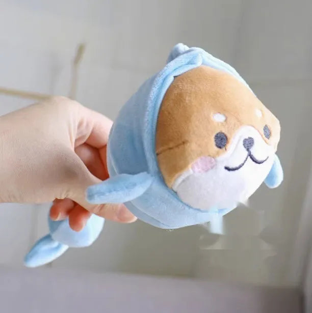 Plush dog toys in Xiaojiu butt, seal, whale, dolphin, and Shiba Inu shapes on a light background