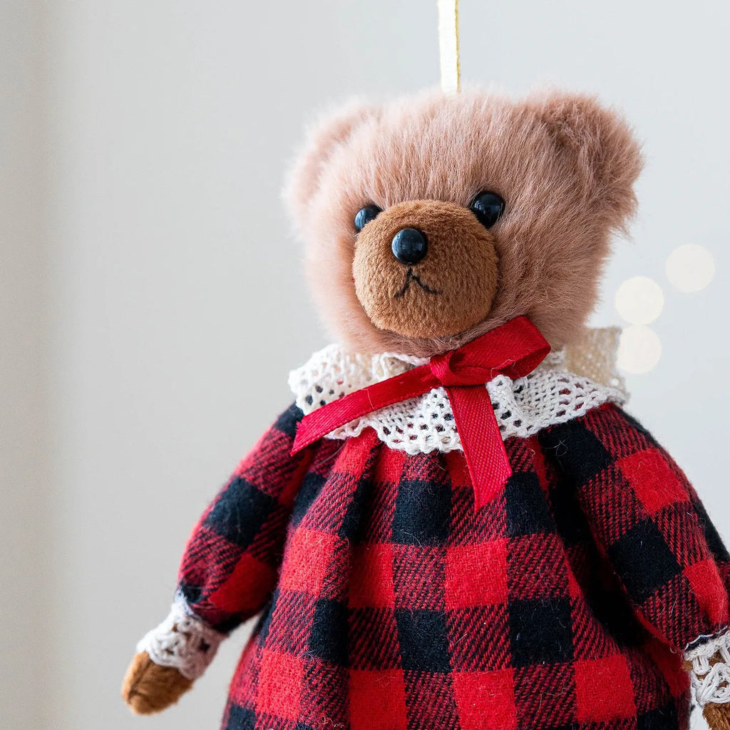 Pair of plush bear dolls wearing red and black plaid cotton clothing, cartoon style.