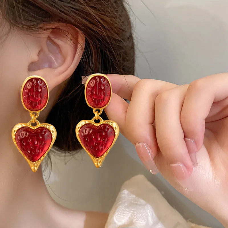 Silver textured oval love heart stud earrings in purple, red, green, and yellow white on a jewellery card.