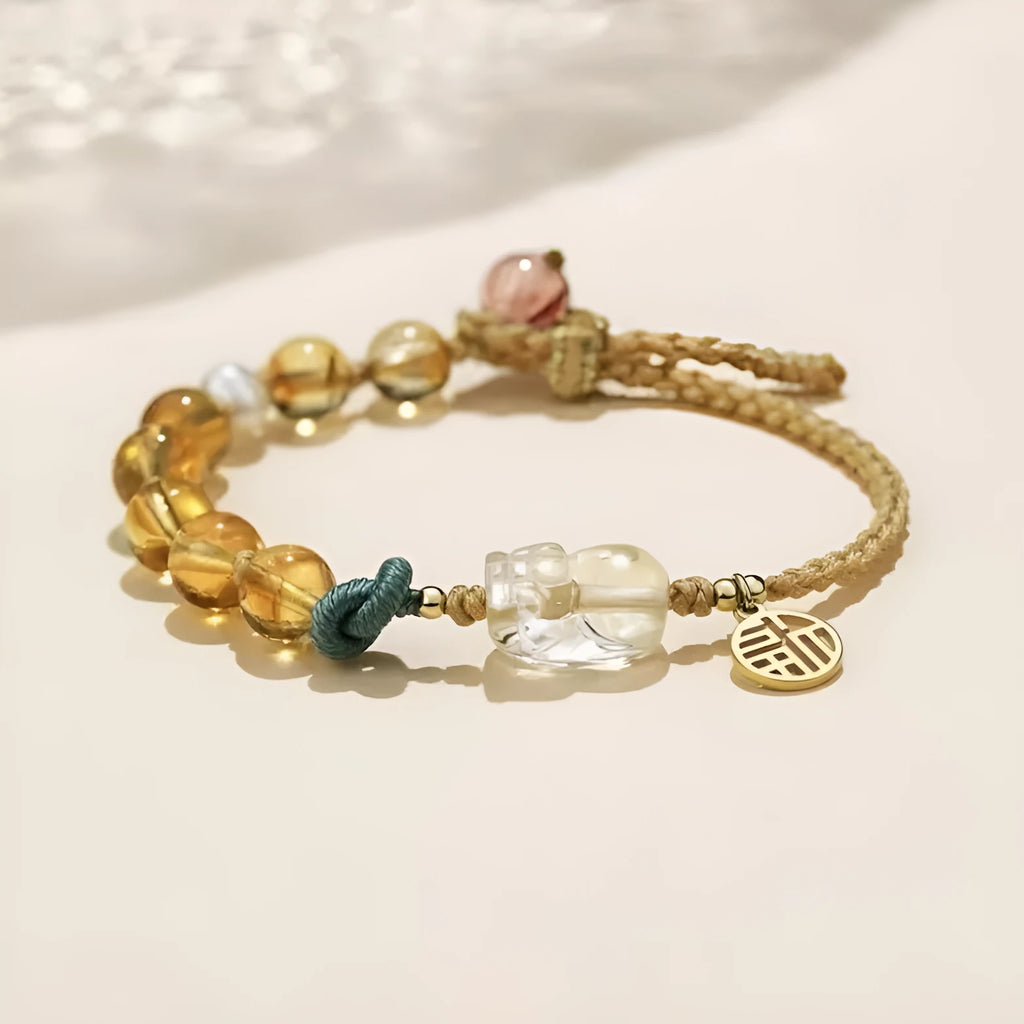Hand-woven citrine crystal bracelet with zodiac animal design on wrist