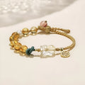 Hand-woven citrine crystal bracelet with zodiac animal design on wrist