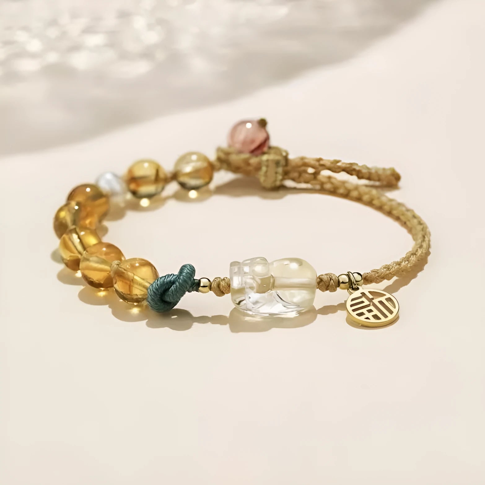 Hand-woven citrine crystal bracelet with zodiac animal design on wrist