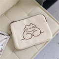 Embroidered fat cat design on a navy blue nylon laptop sleeve with a black zip