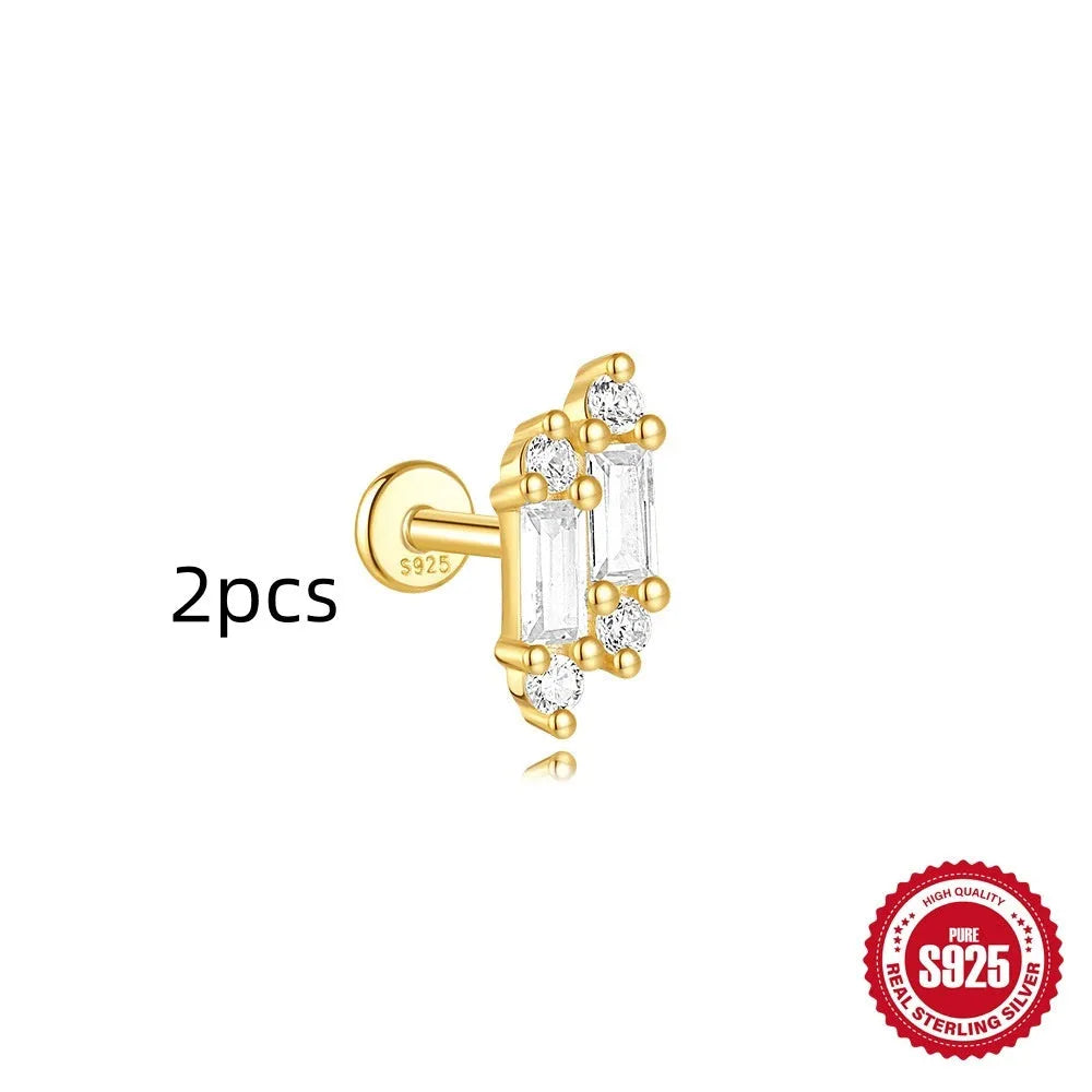 Geometric kite-shaped sterling silver stud earrings with rhinestones and a gold chain tassel.