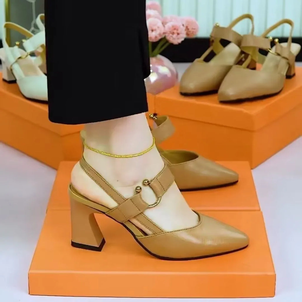 Women's apricot leather closed-toe backless sandals with a chunky heel on a neutral background.