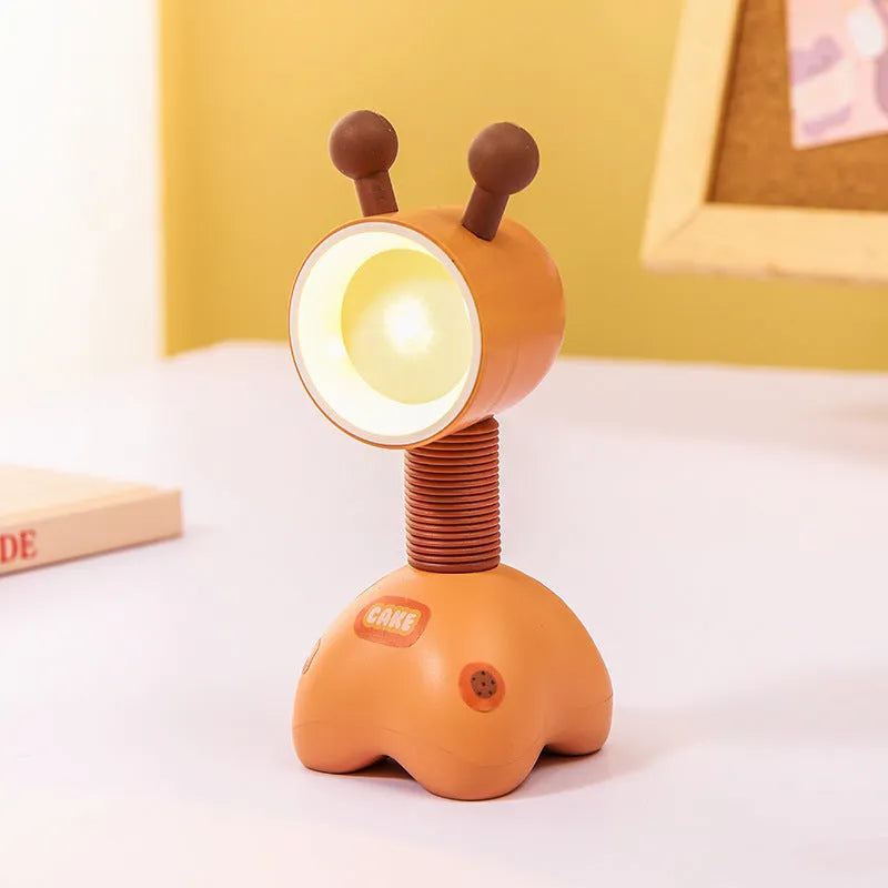 DIY cartoon animal small night lamp with magnetic base in assorted colours on a desk.