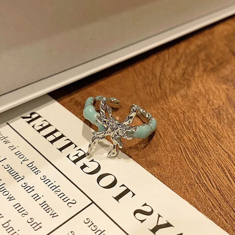 Copper butterfly women's ring with oil-drip finish showing open-loop design