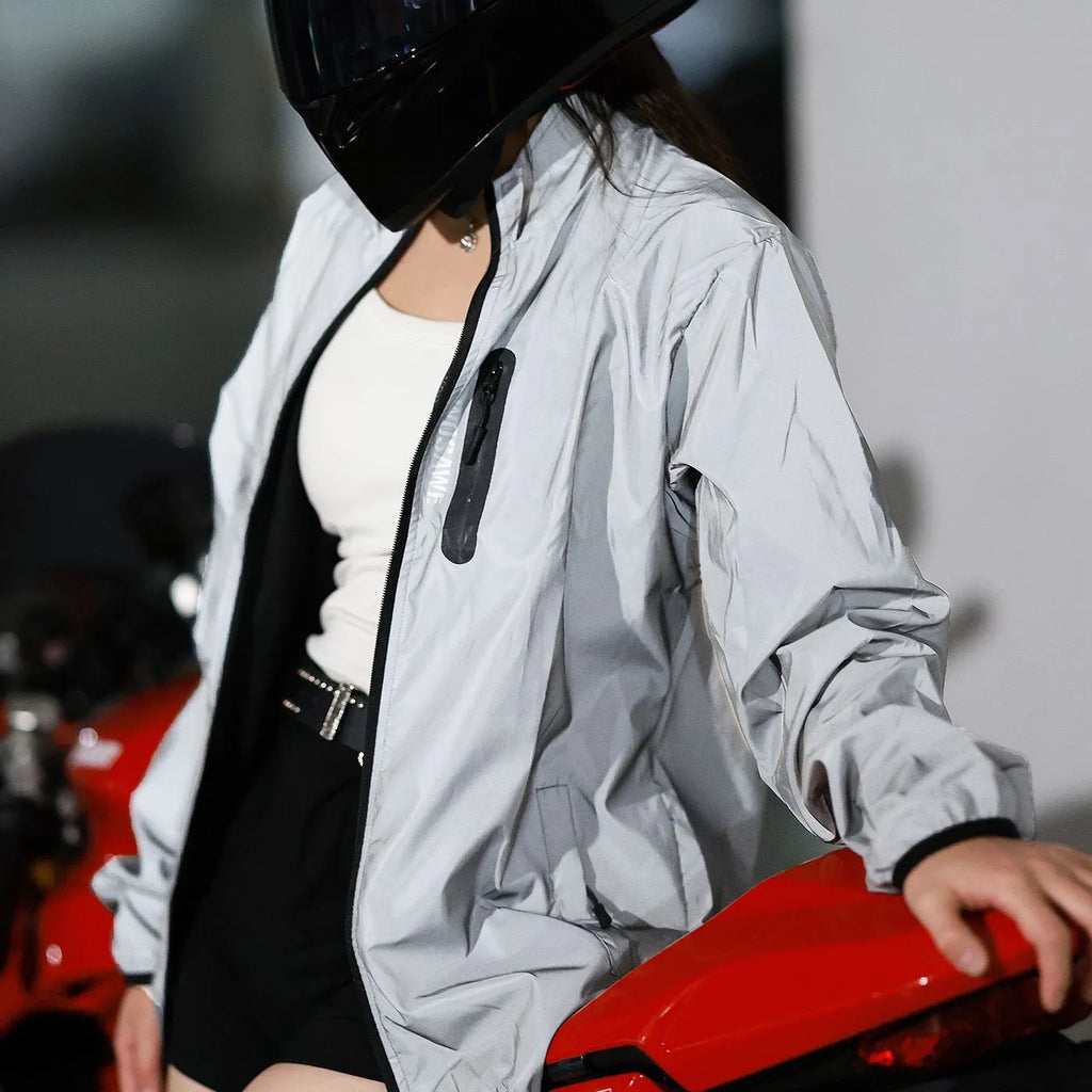 Silver waterproof polyester long sleeve windproof coat on a hanger.