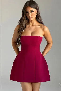 Women's black backless tube dress with short A-line skirt on a hanger.