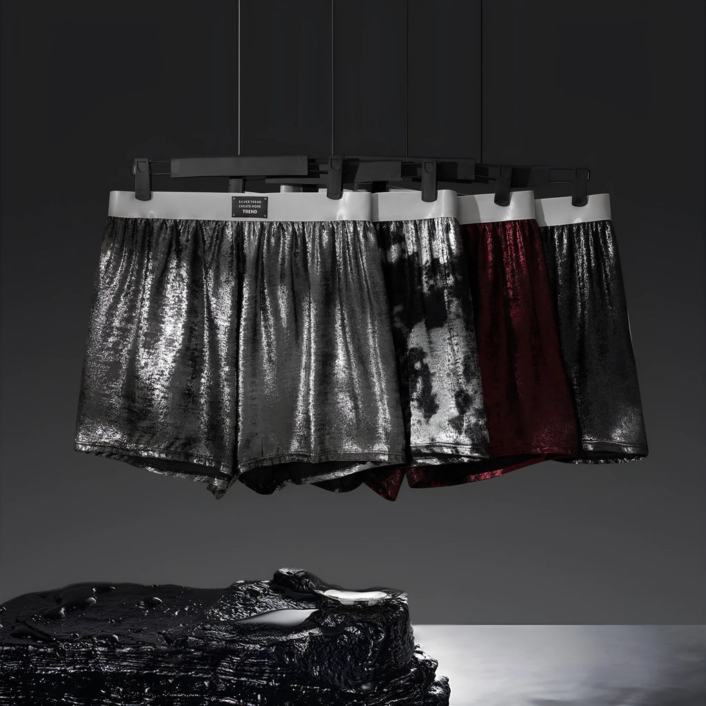 Man wearing galaxy reflective silver loose-fit woven polyester sports shorts.