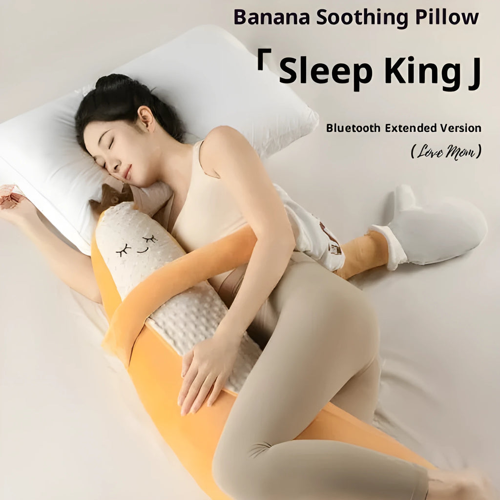 Banana King sleeping soft pillow toy in yellow plush with curved shape on a neutral background