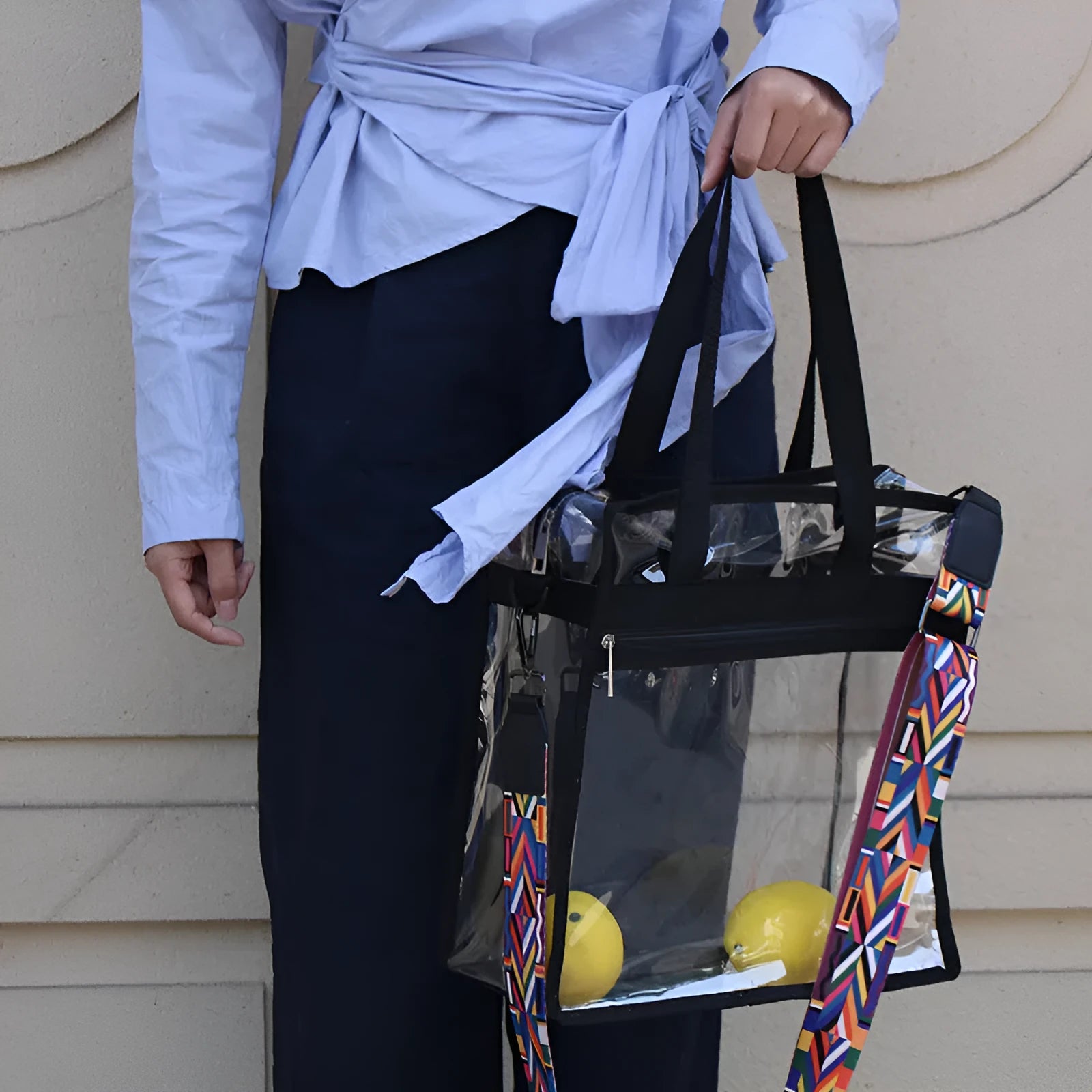 Women's transparent PVC messenger bag showing three-dimensional pocket and crossbody shoulder straps