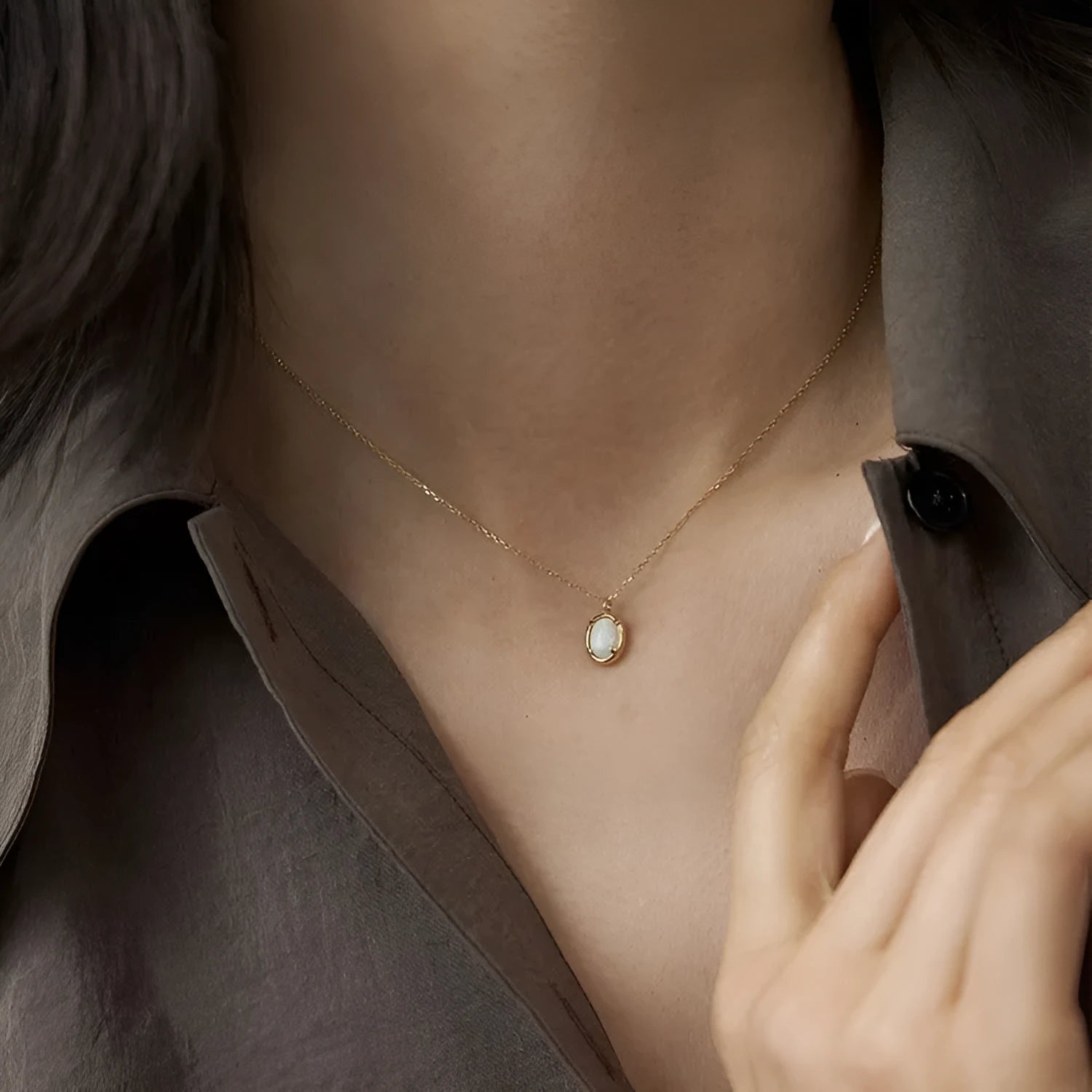 Geometric oval jelly opal pendant necklace on a chain in gold or silver tone.