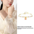 S925 silver bracelet with pink gradient cherry blossom pendant and Hetian jade beads on display