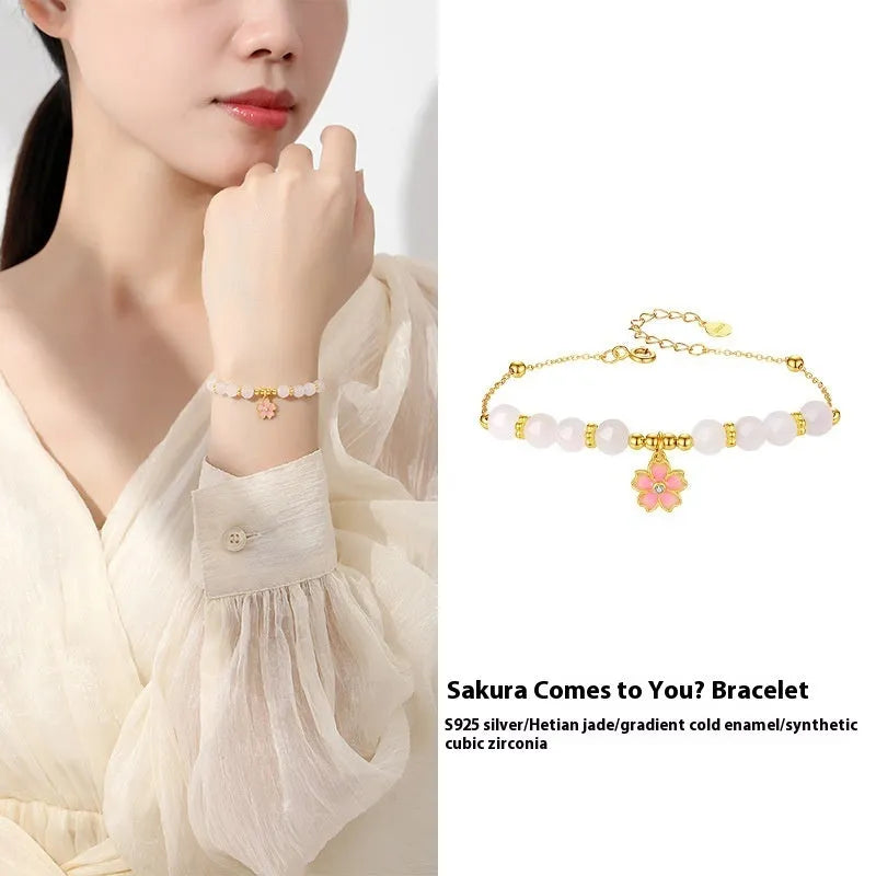 S925 silver bracelet with pink gradient cherry blossom pendant and Hetian jade beads on display