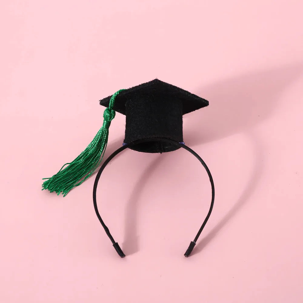 Small pet wearing a woolen felt doctor's degree hair band with a red cap bow tie attached