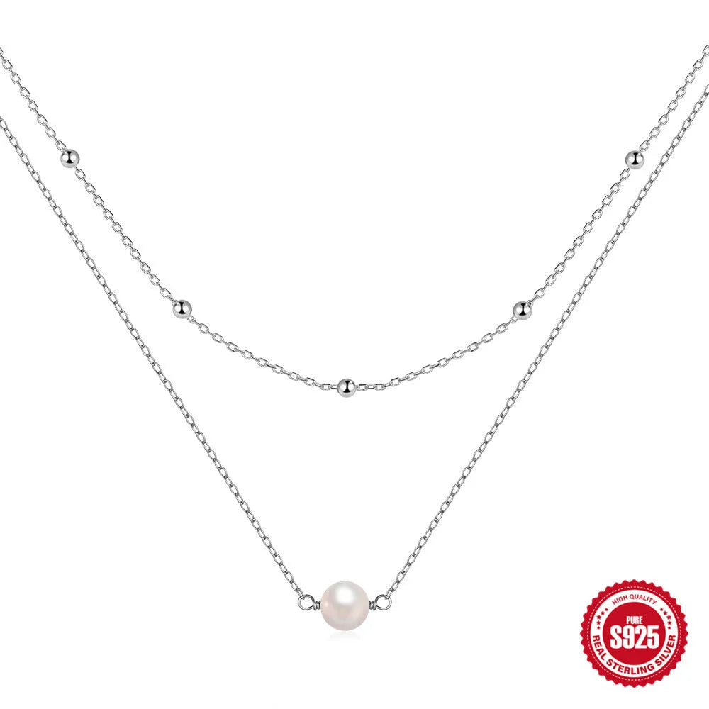 S925 sterling silver double layer necklace with twin geometric pearls in gold or white gold plating.