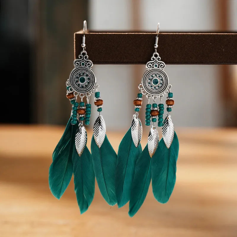 Round drop feather earrings with leaf patterning in alloy, available in multiple electroplated colours.