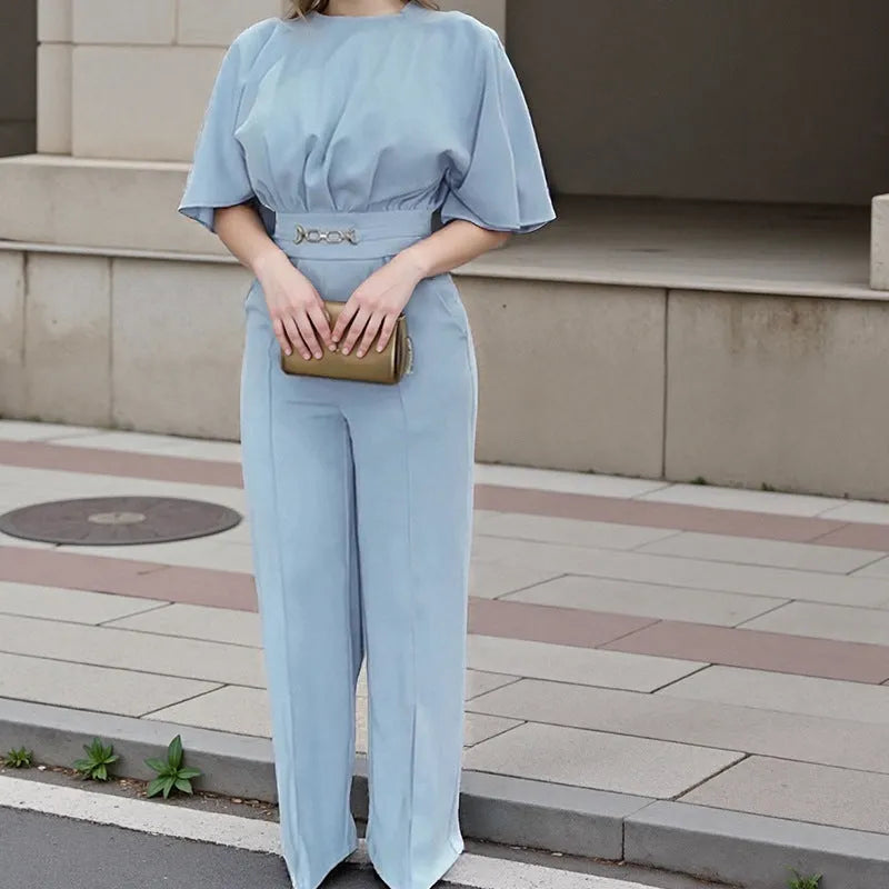 Blue two-piece polyester suit with long sleeves and trousers on a hanger