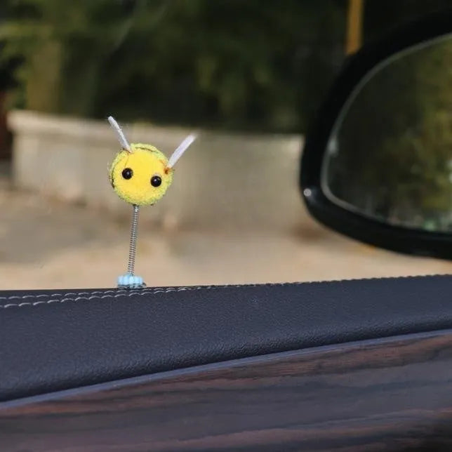 Yellow and black cartoon bee car decoration made from fur ball material measuring 3x3cm