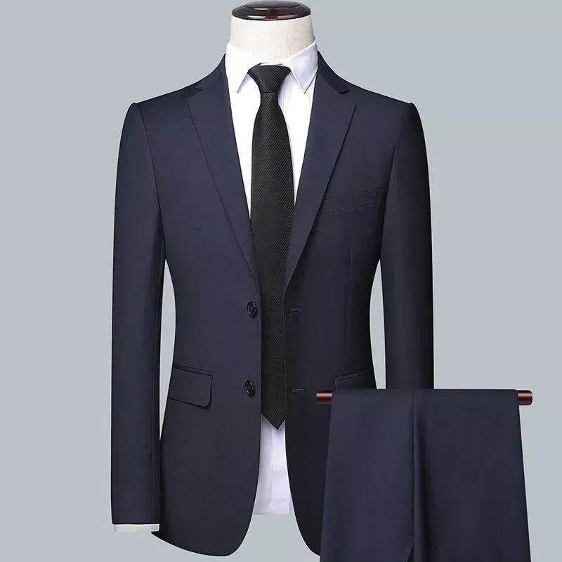 Men's slim fit three-piece suit set in black, including jacket, trousers, and tie on a hanger.