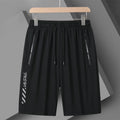 Man wearing black loose-fit quick-drying nylon sports shorts with a five-inch length.