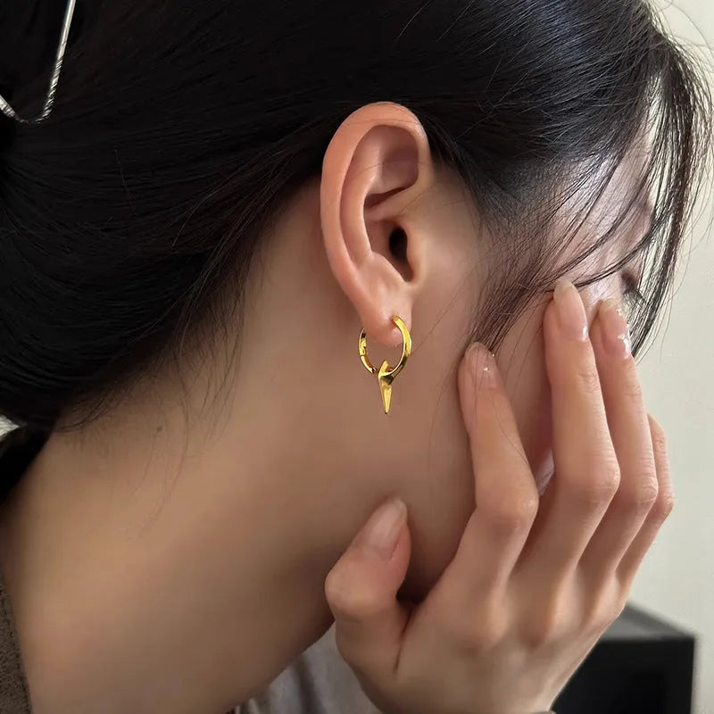 Gold electroplated copper star-shaped ear clips for women, showing geometric design.