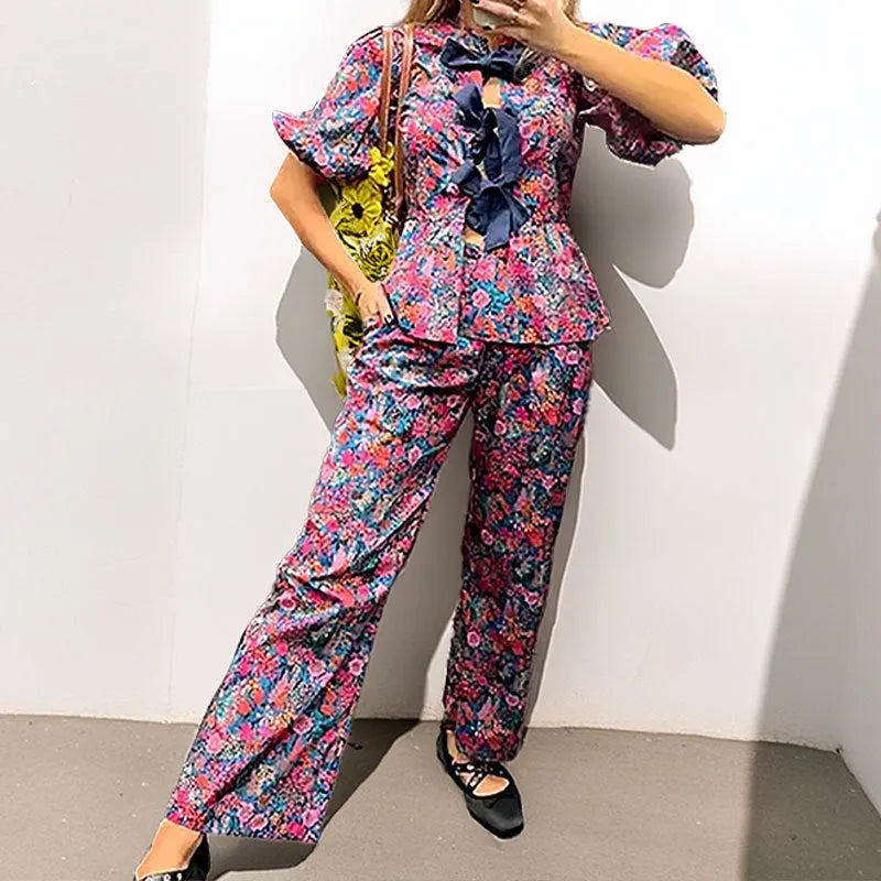 Women's floral print trouser suit set with tie-neck blouse and puff sleeves