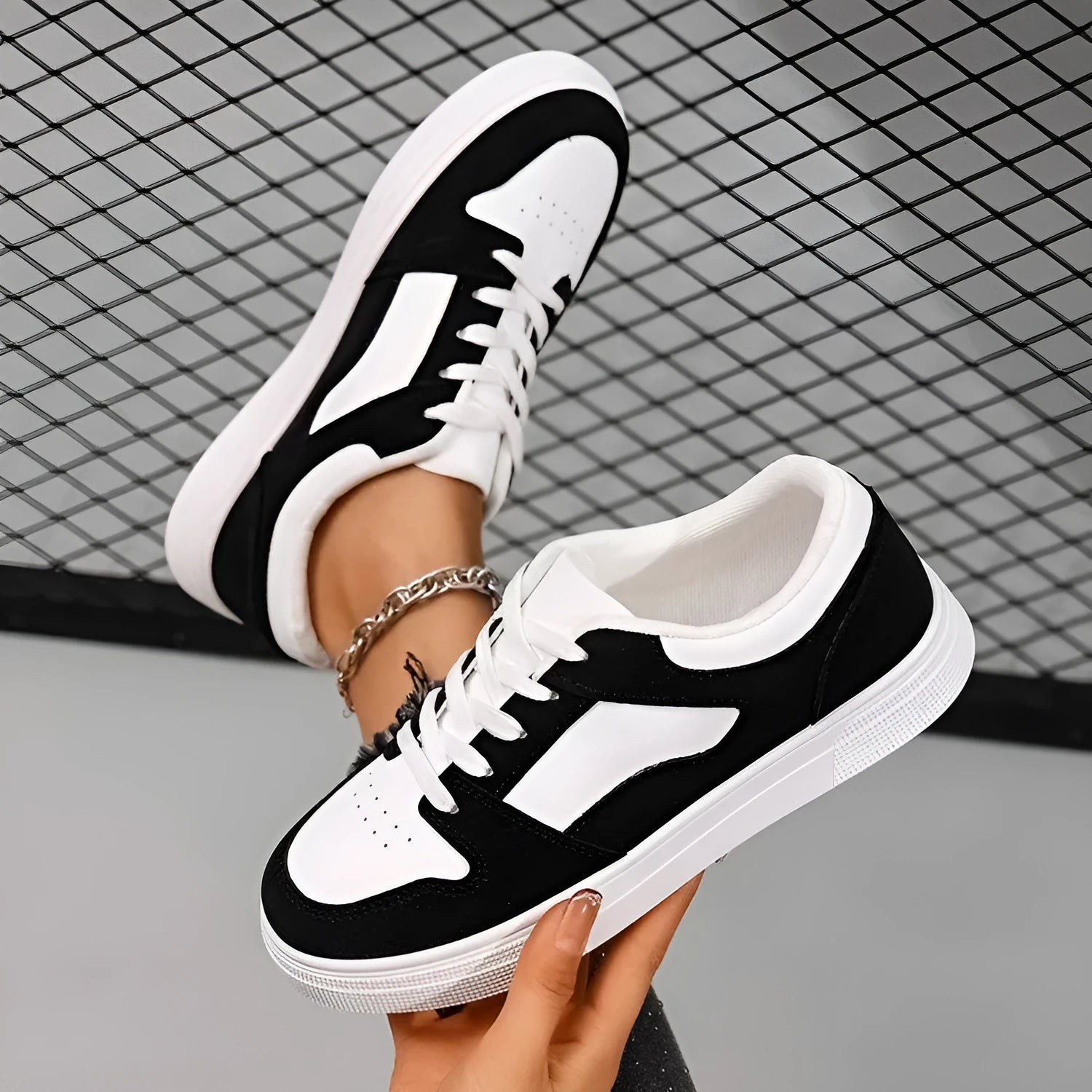 Black women's lace-up casual trainers with a round toe, low top, and rubber sole.