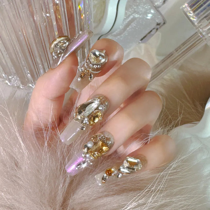 False nail patches with rhinestone detail on card paper packaging showing S number sizing