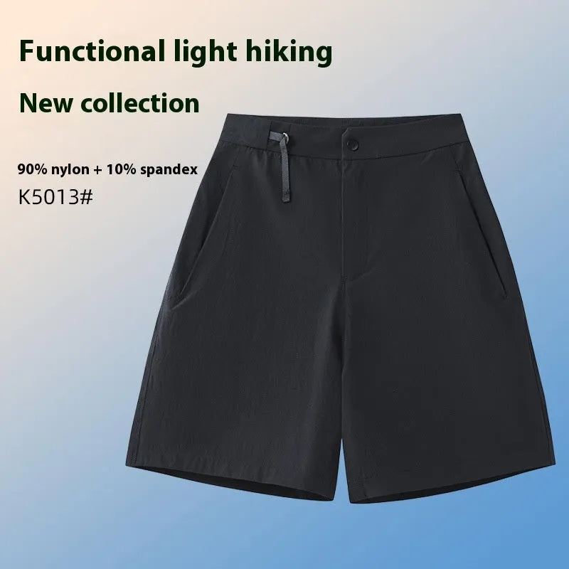 Men's solid colour quick-dry sports shorts with elastic sides on a neutral background.