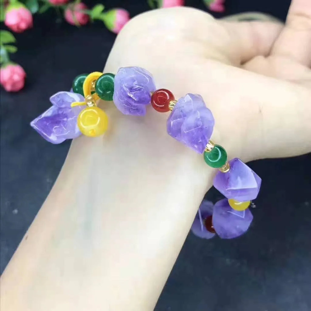 A women's bracelet made of purple natural amethyst beads with a fu character charm.