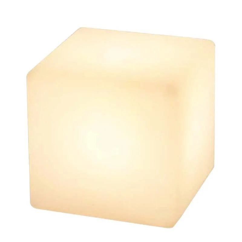 Modern white LED cube stool light outdoors, showing flat top and clean design.