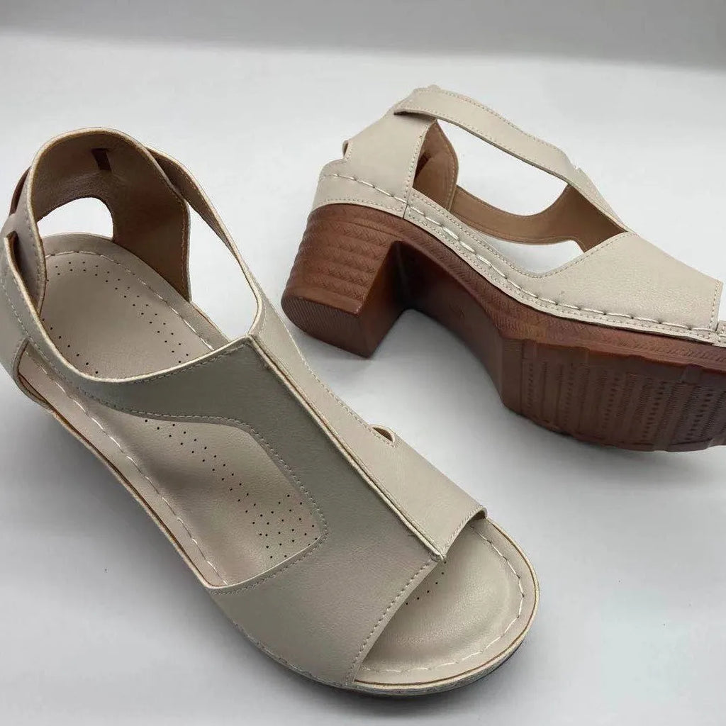 Women's white peep toe wedge sandals with a buckle strap on the ankle.