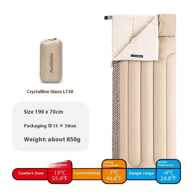 Four seasons camping sleeping bag in one of three colours with its storage bag, shown laid out.
