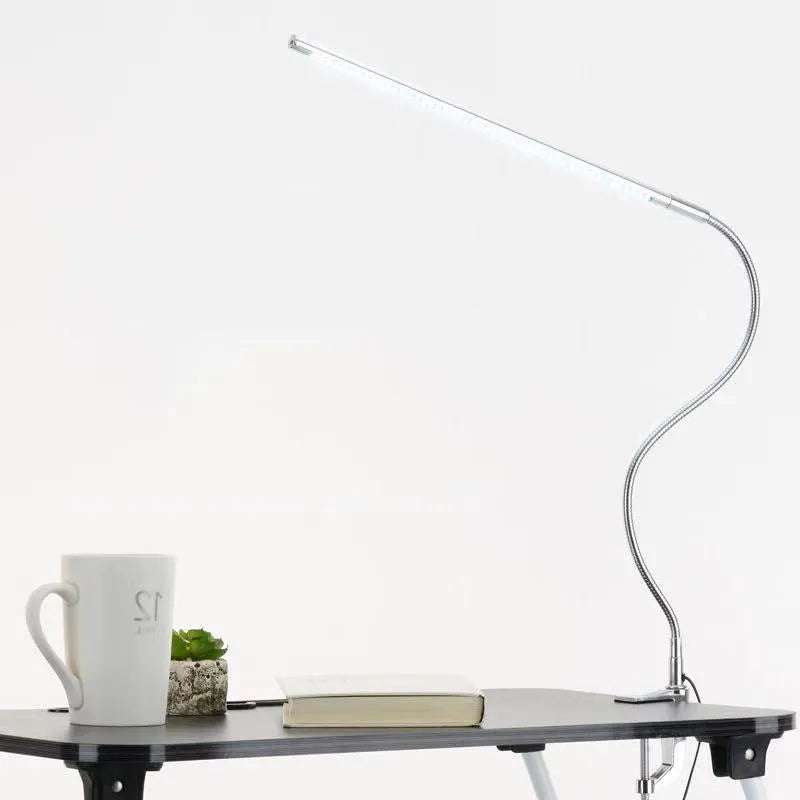 Silver aluminium alloy LED clip-on table lamp with long adjustable arm for nail art lighting.