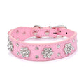 Decorative dog collar made of black PU leather with a pattern of rhinestone flowers and studs, showing the metal D-ring.