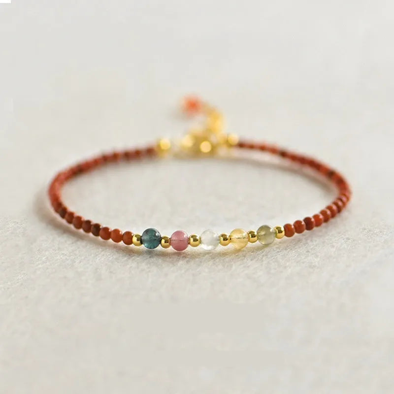 Women's freshwater pearl and geometric crystal bracelet on a stretchy elastic rope.