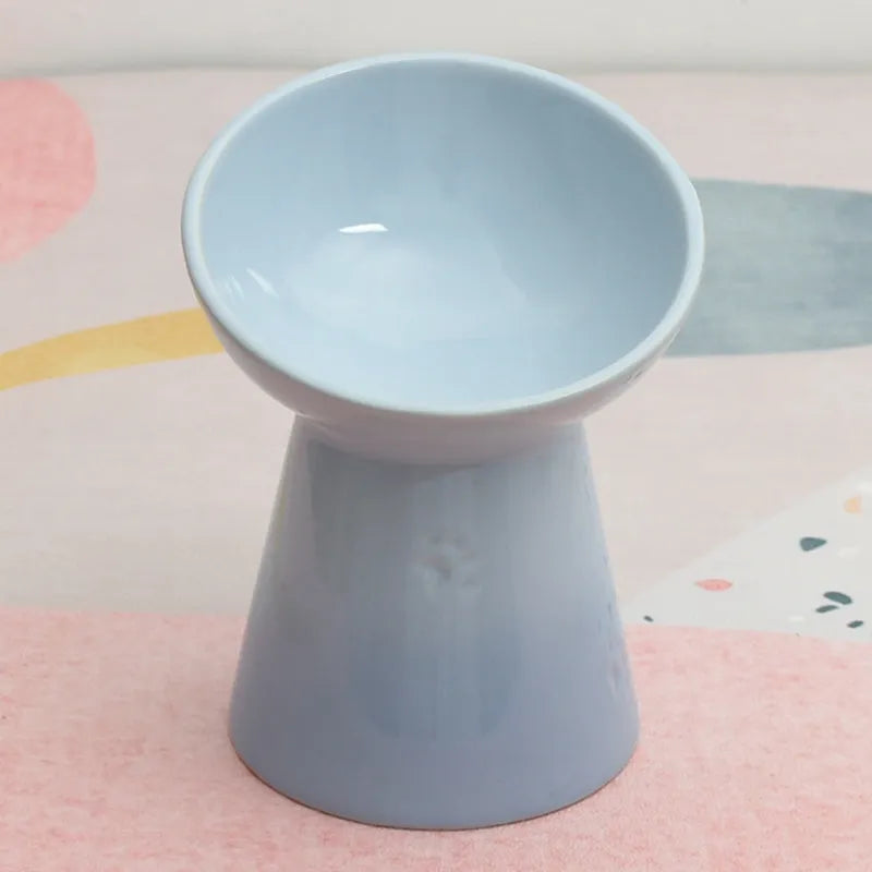 Black chin-high foot ceramic pet bowl for dogs and cats on a flat surface.
