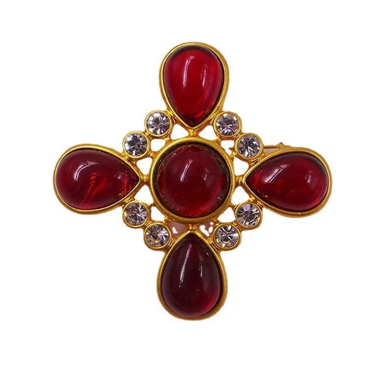 Close-up of a vintage medieval baroque cross brooch with crystals, made from zinc alloy.