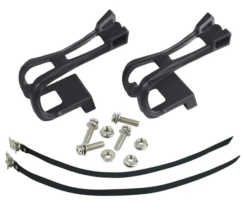 Pair of plastic spinning pedal foot holder covers with lashing straps and metal bolts on a black background