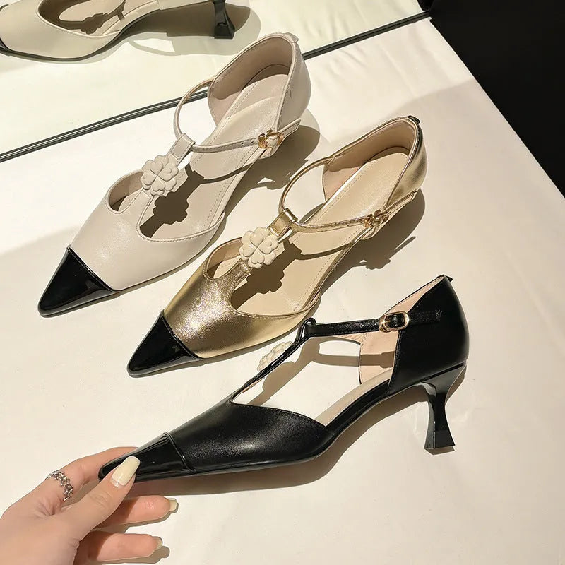 Women's black floral stiletto heel shoe with pointed toe and buckle detail on a beef tendon sole.