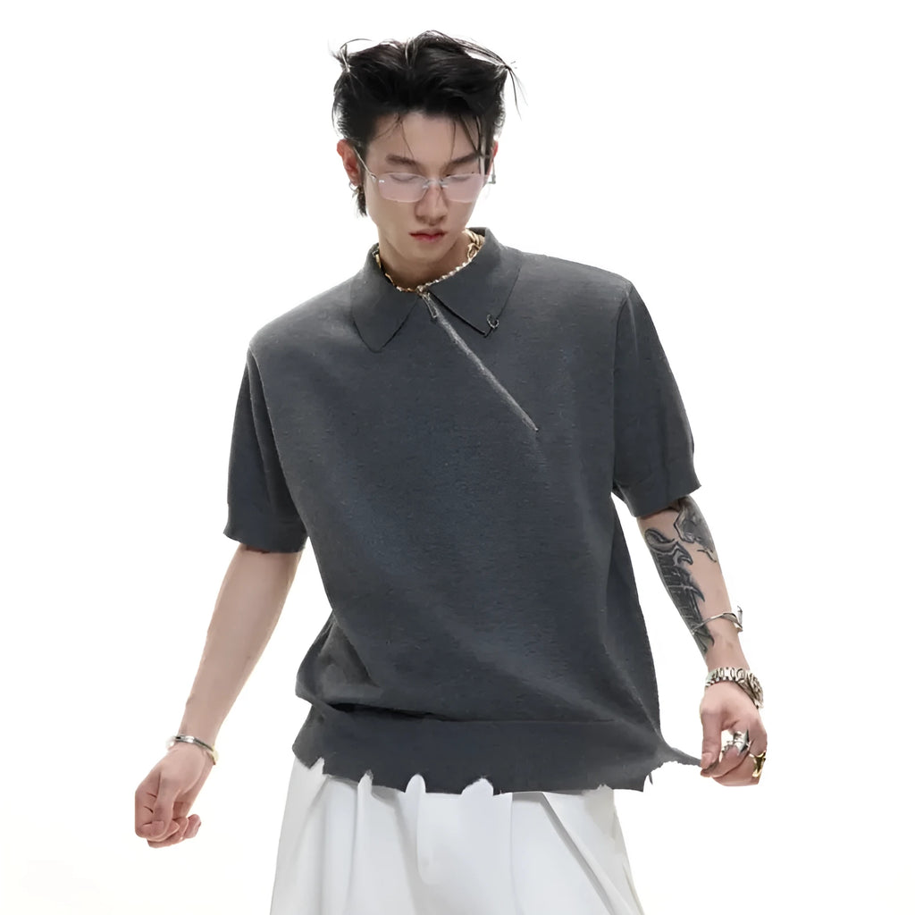 Man wearing a slim-fit black knitted polo shirt with an oblique zip and lapel collar.