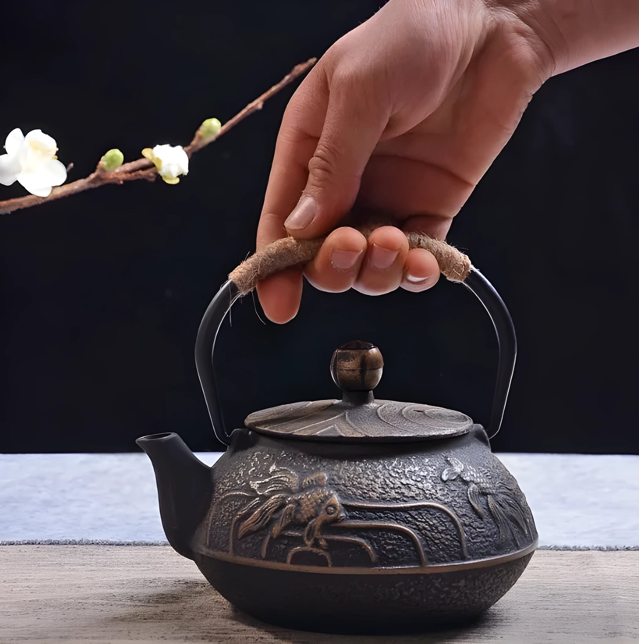 Japanese cast iron teapot in black with Peony pattern, showing lid, handle, and spout.